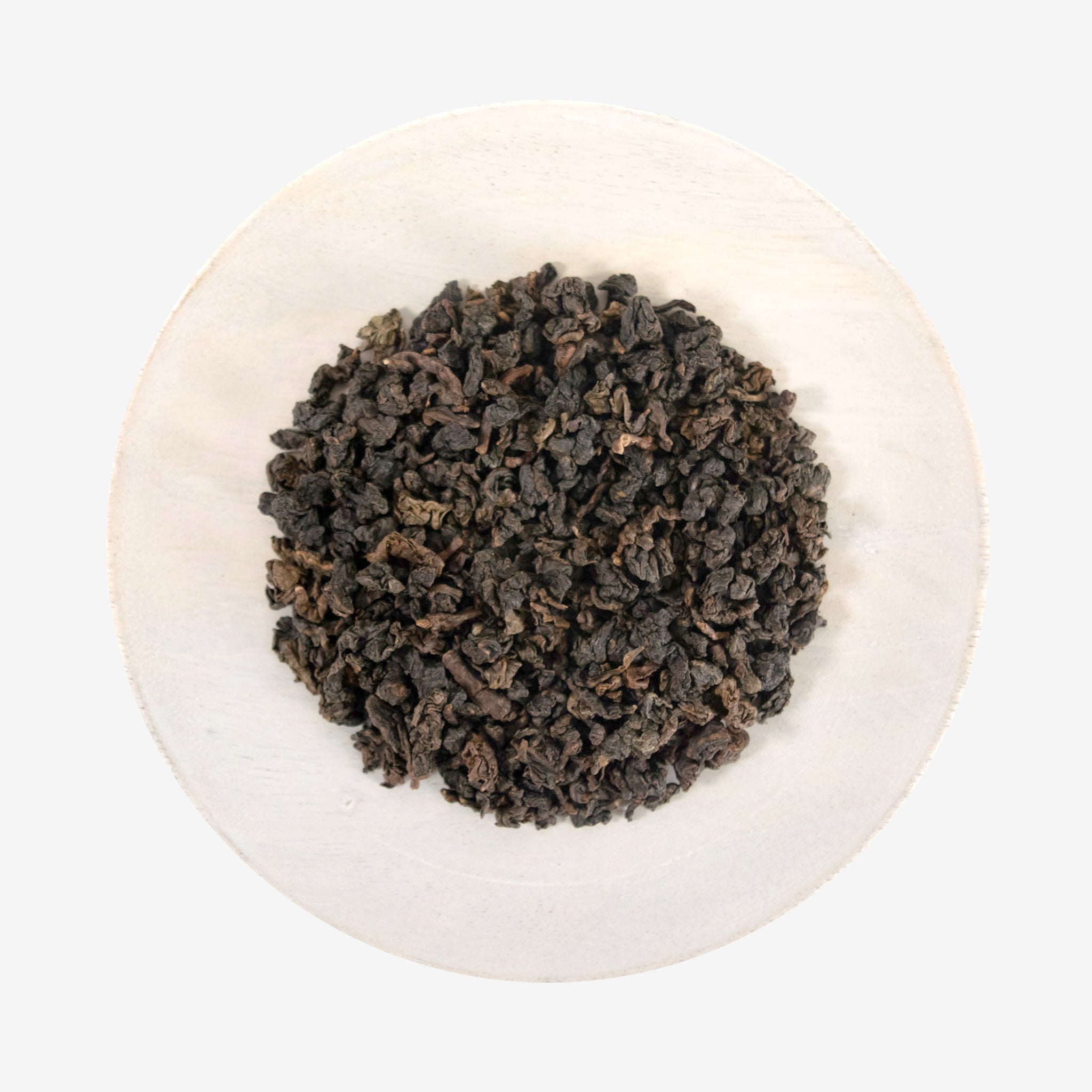 A plate with Tie Guan Yin - Amber Oolong tea leaves.