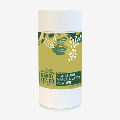 A container of Savoy Signature Matcha Latte Powder with a label showing leaves and matcha powder.