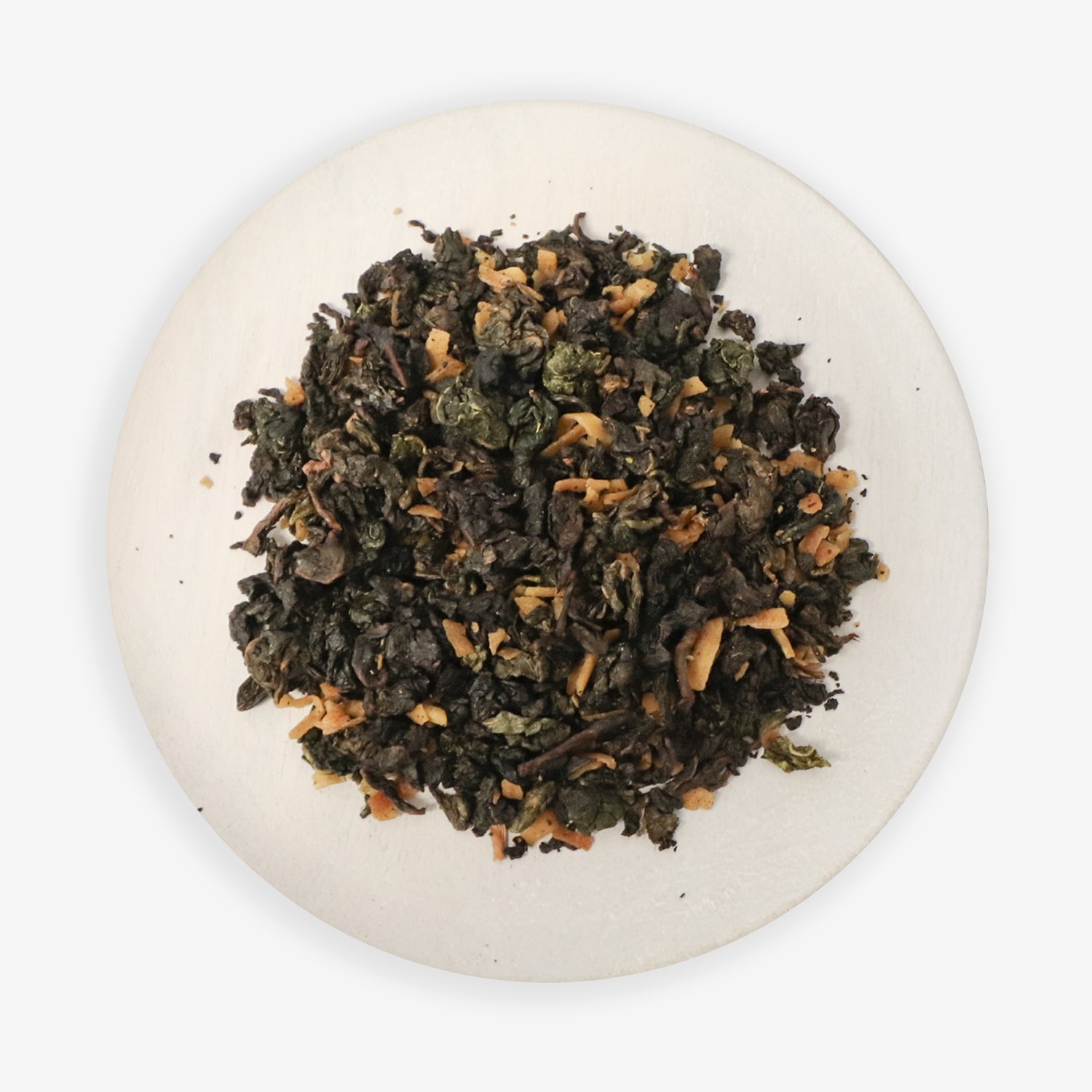 A close-up image of Coconut Oolong tea leaves with pieces of coconut visible, on a white plate against a white background.