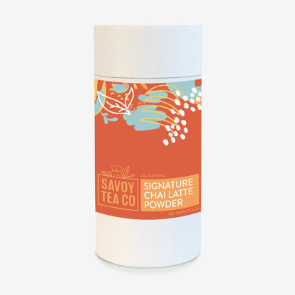 A container of Savoy Signature Chai Latte Powder with a colorful label featuring botanical illustrations.
