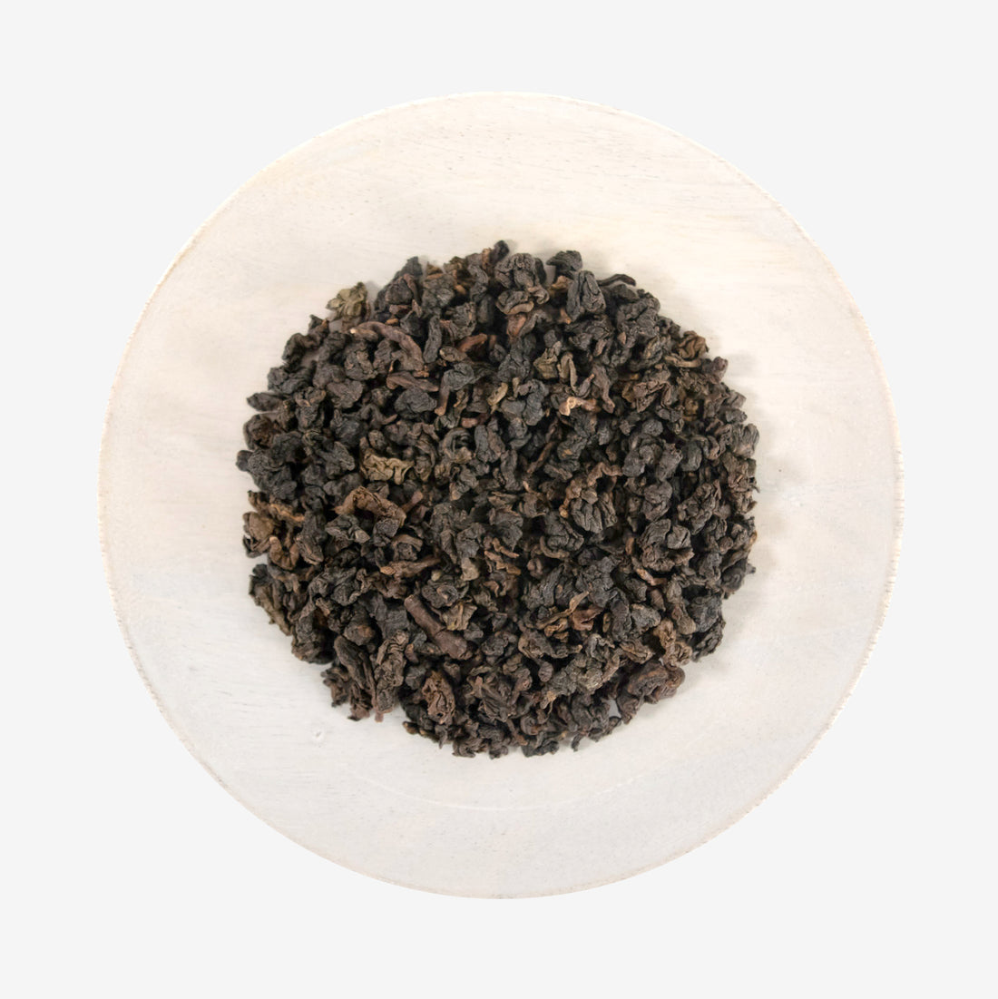 A plate with Tie Guan Yin - Amber Oolong tea leaves.