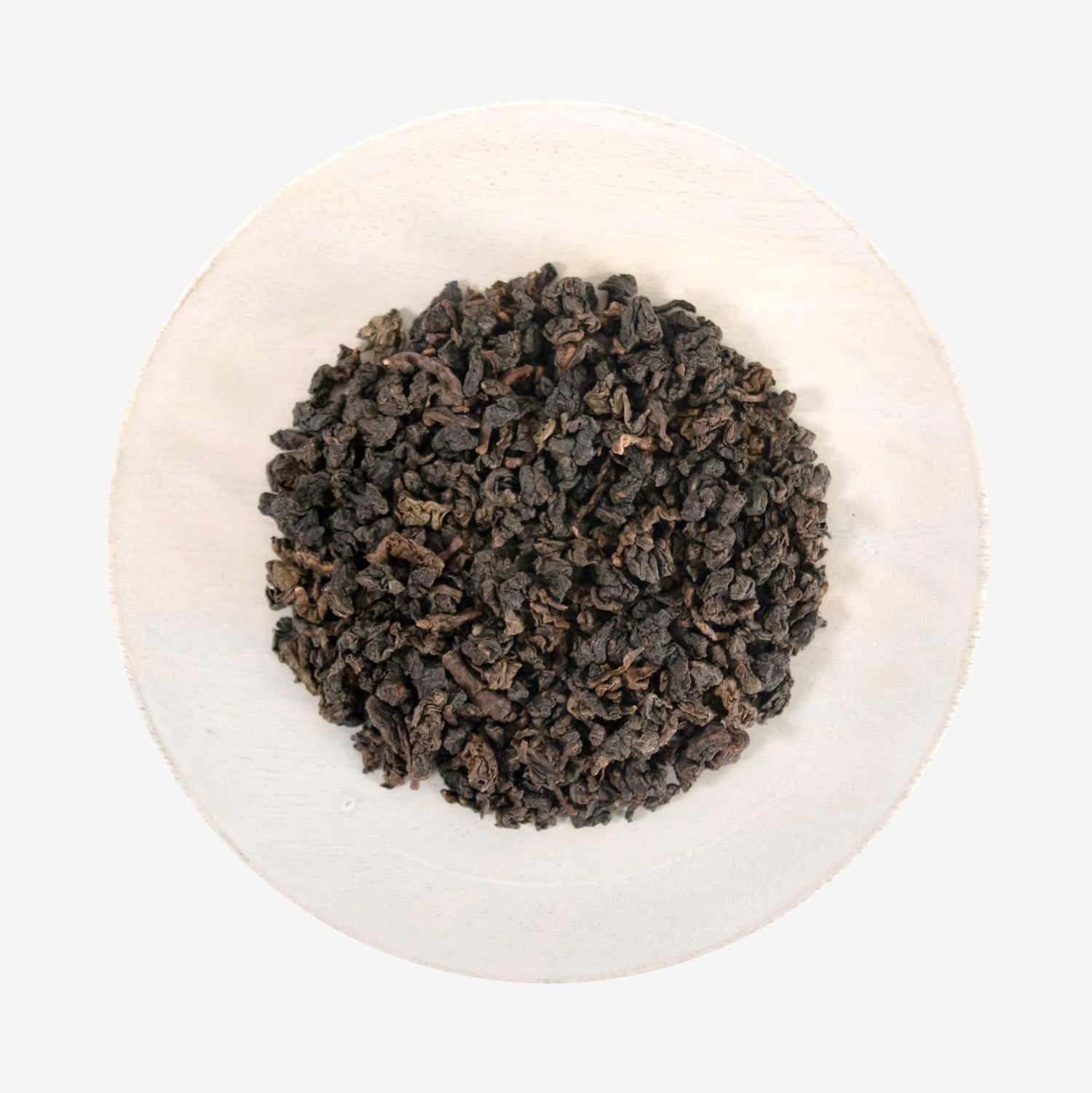 A plate with Tie Guan Yin - Amber Oolong tea leaves.